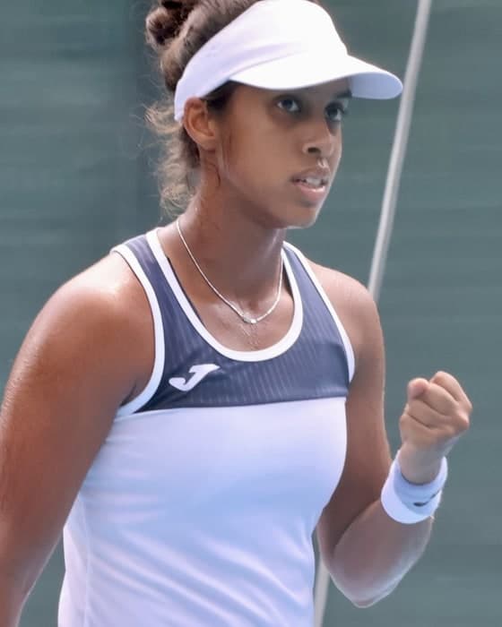 Adithya Karunaratne clenching her fist on court.